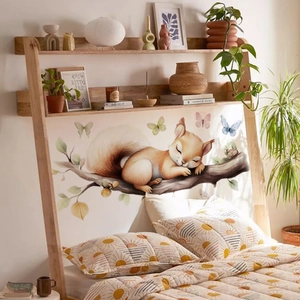 Detail of sleeping squirrel wall sticker with butterflies in a cozy bedroom setting