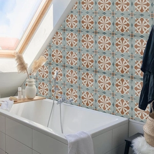 Detail of vintage geometric flower wall tiles in clay red and blue for bathroom decor