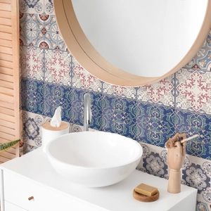 Close-up of mandala tile stickers on bathroom walls with blue and red retro floral patterns