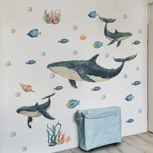 Watercolor ocean theme wall stickers featuring whales and tropical fish in a living room