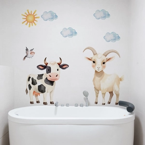 Detailed view of hand-painted animal wall stickers with cows and goats in bathroom decor