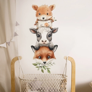Detail of watercolor animal wall stickers showing a fox, sheep, and cow in a nursery room