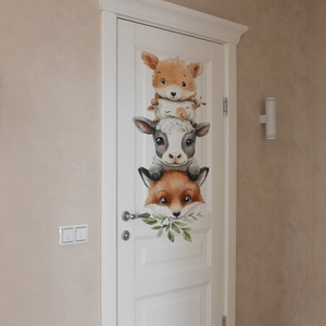 Detailed view of watercolor cartoon animal wall stickers applied to a white interior door