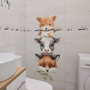 Detail showing stacked cartoon animals wall decals on a modern beige bathroom tile wall