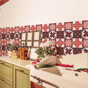 Detail of vintage mosaic marble tile stickers with red and black geometric floral patterns