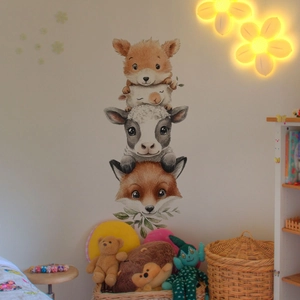 Detail of hand-drawn forest animal wall stickers with fox and deer in kids' room