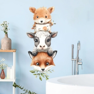 Detail of watercolor animal wall stickers featuring a fox, sheep, and cow in a cozy bathroom