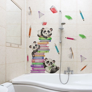 Macro shot of cartoon panda and colorful book wall stickers on light bathroom tiles
