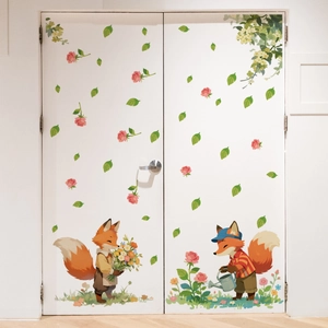 Detail of cartoon fox and flower wall stickers applied to a white interior door