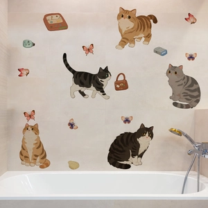 Detail of cute cartoon cats and butterflies wall stickers applied on a bathroom wall