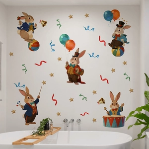Close-up of circus rabbit wall decals with balloons and drums on a white bathroom wall