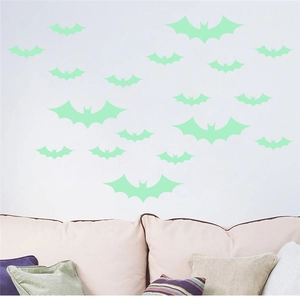 Luminous bat wall stickers in various sizes displayed on a modern living room wall