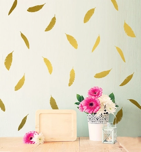 Golden feather vinyl wall stickers arranged in a stylish Nordic home decor setting