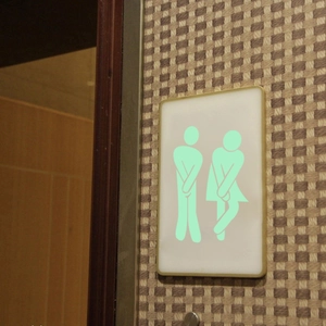 Luminous toilet wall sticker with glowing male and female figures for bathroom doors