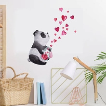 Watercolor panda wall sticker with red hearts in a cozy home living room setting