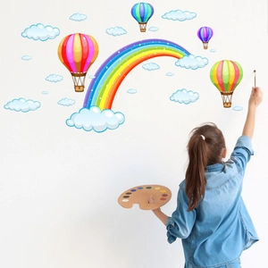 Detailed view of colorful rainbow and hot air balloon wall decals in a child nursery