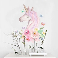 Detail of pink unicorn wall sticker with watercolor flowers and butterflies on white wall