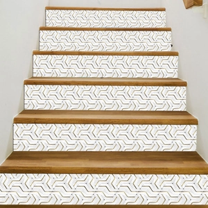 Detail of 3D geometric gold and white tile stickers applied on a wooden staircase