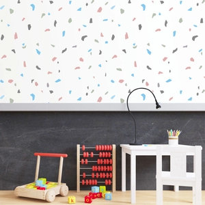Detail of colorful terrazzo stone wall stickers in a minimalist nursery room setting