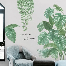 Detail of tropical Monstera deliciosa wall decals in a modern living room setting
