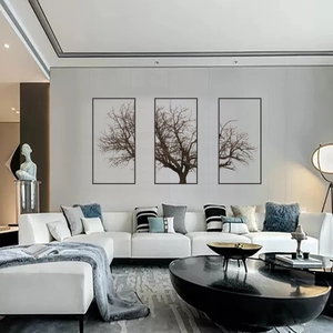 Three-piece Nordic gray tree wall art set with black frames over a modern sofa