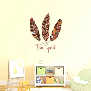 Detail view of Bohemian feather wall decals with Free Spirit quote in a cozy nursery