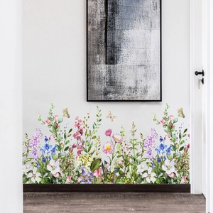 Detail view of floral wall stickers with colorful wildflowers and butterflies on white walls