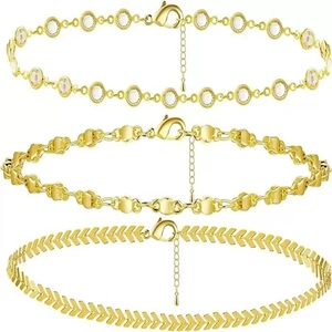 Gold layered beaded and herringbone chain bracelets set with rhinestone details