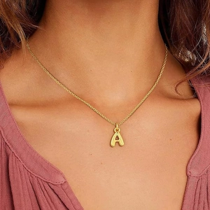 Chic gold-plated bubble letter A pendant necklace for women on stylish female model