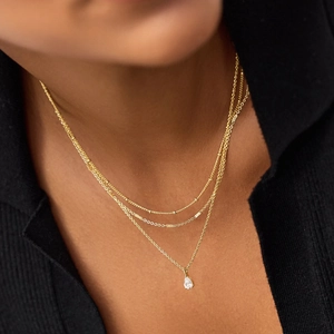 Three-layer gold titanium steel necklace featuring water-drop crystal and tiered chains