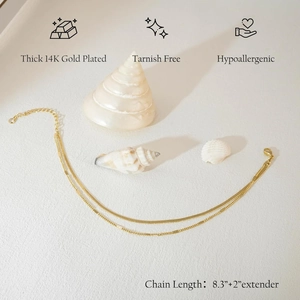 Layered 14K gold plated anklet with snake chain and beads on beach-style background
