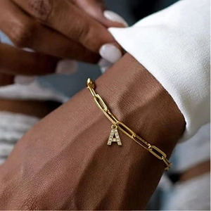 Golden paperclip chain bracelet with a sparkling diamond-encrusted letter A pendant charm