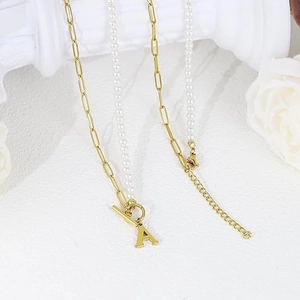 Elegant gold chain and pearl necklace with 'A' initial pendant and OT toggle clasp