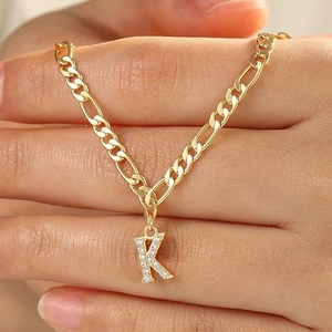 Gold layered Figaro chain necklace with a pave cubic zirconia letter K pendant for women