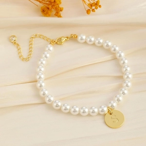 Elegant gold pearl bracelet with letter S coin pendant and adjustable lobster clasp