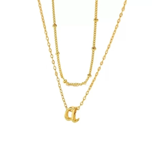 Layered gold necklace featuring a dainty bead chain and an lowercase 'a' letter pendant