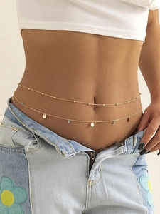 Detail of bohemian double-layer waist chain with gold discs and turquoise beads