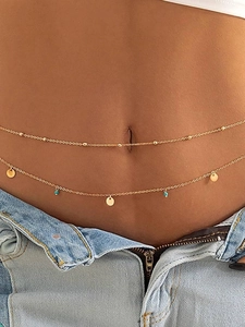 Detail of double-layer gold waist chain featuring turquoise beads and metal sequins