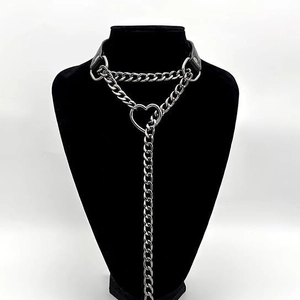 Punk heart choker necklace with silver-tone chain and black strap on a bust display
