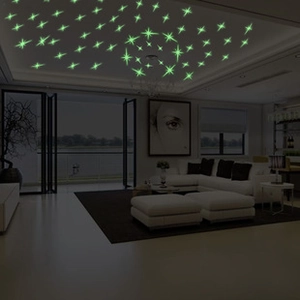 Luminous cross star wall stickers glowing on ceiling in a dark modern living room