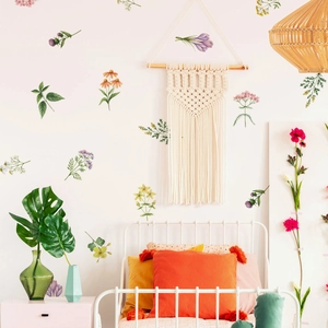Hand-painted floral wall decals in a cozy bedroom with bohemian style decor