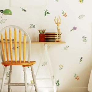 Detailed view of watercolor floral wall stickers in a cozy home office setting with desk