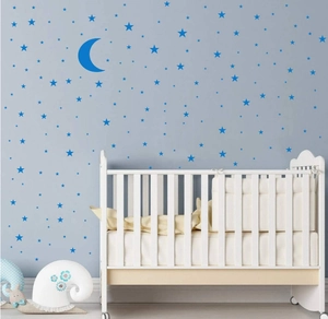 Star and moon wall stickers set shown above a white crib in a cozy nursery room decor