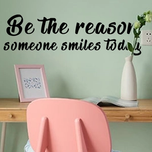 Detail of Be the reason someone smiles today wall decal on a mint green wall