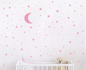Pink moon and star wall stickers set for nursery room DIY decoration over a white crib