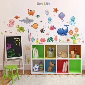 Detail of cartoon sea life wall stickers showing colorful sharks and turtles in a kids room