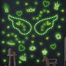 Luminous wall stickers featuring hearts, crowns, and wings glowing in the dark for bedroom