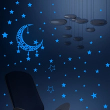 Luminous blue moon and stars wall decals glowing in a dark room for kids' bedroom decor