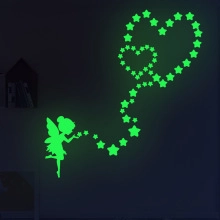 Luminous wall sticker showing a fairy blowing stars into heart shapes in the dark