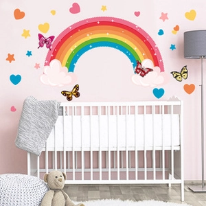 Detailed view of rainbow and clouds wall stickers in a cozy nursery room setting